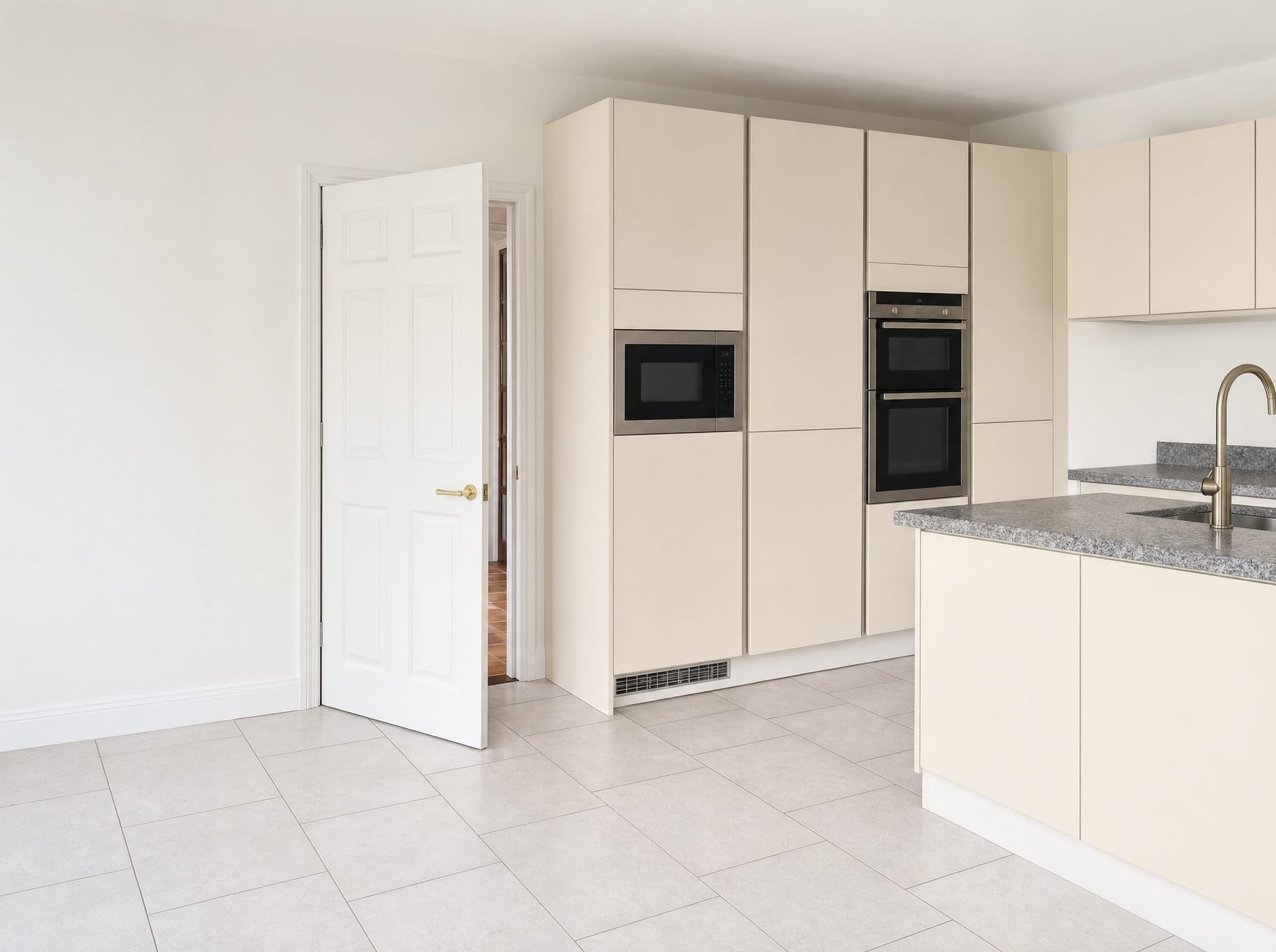 Handleless cream high-gloss kitchen tall units with built-in microwave and double oven